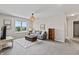 Cozy living room with large windows, neutral tones, and comfortable seating at 5917 Bartley Dr, Noblesville, IN 46062