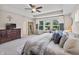Inviting main bedroom featuring a large dresser and windows overlooking the landscaped outdoors at 5917 Bartley Dr, Noblesville, IN 46062