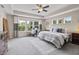 Spacious main bedroom with a tray ceiling, plush carpeting, and multiple windows offering natural light at 5917 Bartley Dr, Noblesville, IN 46062