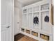 Well-organized mudroom with built-in storage, coat hooks, and shoe baskets is right off the entryway at 5917 Bartley Dr, Noblesville, IN 46062