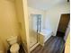 Well-lit bathroom featuring a tub with jets next to a glass shower and a view of a closet at 5938 Tybalt Ln, Indianapolis, IN 46254