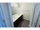 Well-lit bathroom featuring double sinks with a vanity, an extra large mirror, and modern fixtures at 5938 Tybalt Ln, Indianapolis, IN 46254