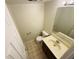 Small half-bath featuring a modern vanity and toilet, ideal for guests, with tile flooring at 5938 Tybalt Ln, Indianapolis, IN 46254