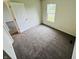 Clean bedroom featuring neutral walls, plush carpeting, closet, and plenty of natural light at 5938 Tybalt Ln, Indianapolis, IN 46254