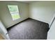Clean bedroom with neutral walls, plush carpeting, bright window, and ample natural light at 5938 Tybalt Ln, Indianapolis, IN 46254