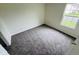 Cozy bedroom with neutral walls, plush carpeting, and a bright window for natural light at 5938 Tybalt Ln, Indianapolis, IN 46254