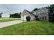 Two-story home featuring a brick facade, attached garage, and a well-manicured front lawn at 5938 Tybalt Ln, Indianapolis, IN 46254