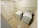 Functional laundry room featuring a side-by-side washer and dryer setup and ample storage at 5938 Tybalt Ln, Indianapolis, IN 46254