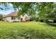 Large backyard with a well-kept lawn, a wooden deck, and privacy fencing, perfect for outdoor activities and entertaining at 6050 Acorn Dr, Columbus, IN 47201