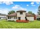 Exterior rear view shows a home featuring a wooden deck and a spacious green lawn at 6050 Acorn Dr, Columbus, IN 47201