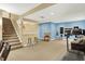 Spacious basement area with stairs, a partial kitchen, and fitness equipment, ideal for recreation and exercise at 6050 Acorn Dr, Columbus, IN 47201