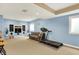 Spacious finished basement features neutral carpet, a comfortable sofa, and a treadmill for exercise at 6050 Acorn Dr, Columbus, IN 47201