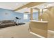 Inviting basement featuring a comfortable sofa, treadmill, and a bar, perfect for unwinding and entertaining at 6050 Acorn Dr, Columbus, IN 47201