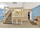 Finished basement area boasts a bar with seating and staircase to upper level, ideal for gatherings at 6050 Acorn Dr, Columbus, IN 47201