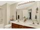 Bright bathroom features a double vanity, a large mirror, and a shower-tub combination at 6050 Acorn Dr, Columbus, IN 47201