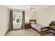 Inviting bedroom features a twin bed, bedside table, window with curtains, ceiling fan, and natural light at 6050 Acorn Dr, Columbus, IN 47201