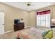 Cozy bedroom featuring a window, carpet flooring, a ceiling fan, and ample space for relaxation at 6050 Acorn Dr, Columbus, IN 47201