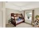 Comfortable bedroom with a wooden bunk bed, ceiling fan, and a window offering natural light at 6050 Acorn Dr, Columbus, IN 47201
