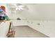 Unique bonus room features sloped ceilings, neutral carpet, decorative accents, and natural light from an arched window at 6050 Acorn Dr, Columbus, IN 47201