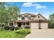 Charming two-story home with well-manicured lawn and a basketball hoop in front of the two-car garage at 6050 Acorn Dr, Columbus, IN 47201