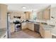 Well-lit kitchen featuring stainless steel appliances, granite countertops, and light wood cabinetry at 6050 Acorn Dr, Columbus, IN 47201