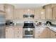 Bright kitchen with stainless steel appliances, light-colored cabinets, and granite countertops at 6050 Acorn Dr, Columbus, IN 47201