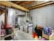 Unfinished basement for utilities and storage includes exposed ceiling, water softener, and is ready for customization at 6050 Acorn Dr, Columbus, IN 47201