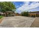 Large backyard features a basketball court, covered patio, seating area, and mature trees at 6143 Schoolwood Dr, Indianapolis, IN 46224