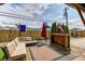 Relaxing backyard features a cozy seating area with a sectional sofa, rug, and decorative flag at 6143 Schoolwood Dr, Indianapolis, IN 46224