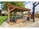 Backyard boasts a covered patio with a ping pong table, bar, and seating area on a stone surface at 6143 Schoolwood Dr, Indianapolis, IN 46224