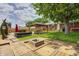 Landscaped backyard with a gazebo, built-in seating, and a fire pit is great for entertaining at 6143 Schoolwood Dr, Indianapolis, IN 46224