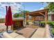 Covered patio area in the backyard with a ping pong table, seating, and a basketball hoop at 6143 Schoolwood Dr, Indianapolis, IN 46224