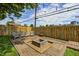 Backyard with a wooden deck, fire pit, string lights, and chairs, perfect for entertaining at 6143 Schoolwood Dr, Indianapolis, IN 46224