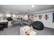 Spacious finished basement with a large seating area, bar, and entertainment options at 6143 Schoolwood Dr, Indianapolis, IN 46224