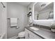 Modern bathroom featuring a sleek vanity, backlit mirror, and subway tile shower at 6143 Schoolwood Dr, Indianapolis, IN 46224