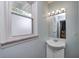 Bathroom features a classic vanity, frosted window, and neutral tones at 6143 Schoolwood Dr, Indianapolis, IN 46224