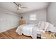 Bedroom with hardwood floors, ceiling fan, and a closet with white doors at 6143 Schoolwood Dr, Indianapolis, IN 46224