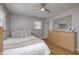 Bright bedroom with hardwood floors, ceiling fan, and neutral-colored furniture at 6143 Schoolwood Dr, Indianapolis, IN 46224