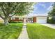 Charming brick home with a well-maintained lawn and mature trees, perfect for curb appeal at 6143 Schoolwood Dr, Indianapolis, IN 46224