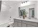 Modern bathroom with double vanity, framed mirror, and tub-shower combo with neutral paint at 6448 Schad Dr, Noblesville, IN 46062