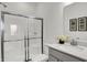 Modern bathroom with a glass-enclosed shower and a vanity with white countertops at 6448 Schad Dr, Noblesville, IN 46062