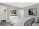 Comfortable bedroom with gray walls, white bedding, and closet, illuminated by a stylish lamp at 6448 Schad Dr, Noblesville, IN 46062