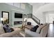 Bright living room with a cozy fireplace, high ceilings, and stylish decor at 6448 Schad Dr, Noblesville, IN 46062