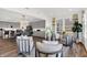 Open-concept living room and kitchen featuring hardwood floors, gray cabinets, and stainless steel appliances at 6448 Schad Dr, Noblesville, IN 46062