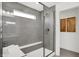 A tiled walk-in shower with a glass door and small window with bench seat at 6448 Schad Dr, Noblesville, IN 46062