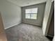 Comfortable bedroom features neutral carpet and a window with a view to the outdoors at 6729 Birmingham Ave, McCordsville, IN 46055