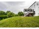 Wide shot of backyard featuring an elevated back deck and a lake in the distance at 6771 Woodcliff Cir, Zionsville, IN 46077