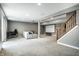 Spacious finished basement with home theater, seating, and stairs to the upper level at 6771 Woodcliff Cir, Zionsville, IN 46077