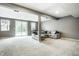 Finished basement with neutral carpet, comfortable seating, and large sliding glass door at 6771 Woodcliff Cir, Zionsville, IN 46077