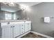 Bathroom featuring double sinks, a large mirror, and ample counter space for a clean and organized space at 6771 Woodcliff Cir, Zionsville, IN 46077